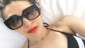 HOT: Karisma Kapoor beats the heat in a hot monochrome swimsuit