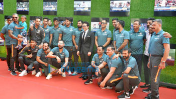 Anushka Sharma and cricketer Virat Kohli pose with Sachin Tendulkar at the premiere of Sachin: A Billion Dreams