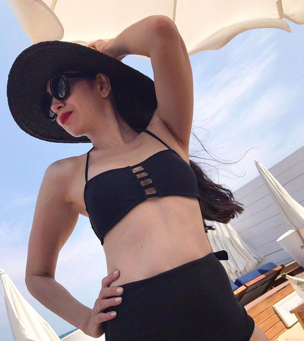 Karisma Kapoor looks smoking hot in this black two-piece swimwear and we can’t stop ogling features