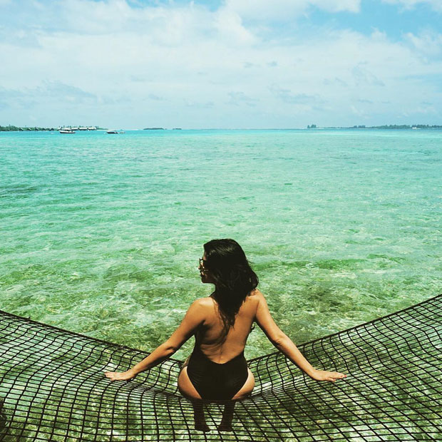 Shenaz Treasury poses sexily on a fishing net in Maldives