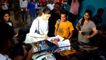 Deepika Padukone cuts a cake for a fan