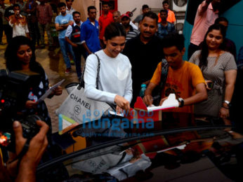 Deepika Padukone cuts a cake for a fan