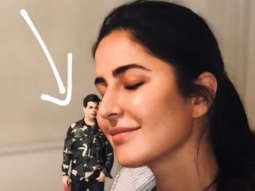 Katrina Kaif poses with a miniature doll of Karan Johar