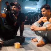 Remo D’souza and a shirtless Varun Dhawan look lost in an intense discussion in this behind-the-scenes picture from Street Dancer 3D
