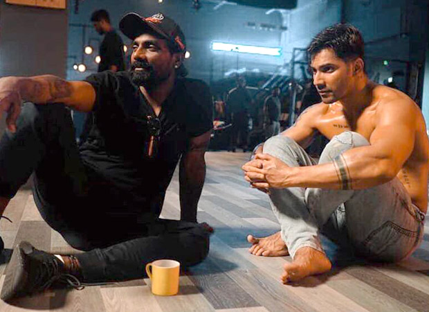 Remo D’souza and a shirtless Varun Dhawan look lost in an intense discussion in this behind-the-scenes picture from Street Dancer 3D