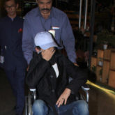 A wheelchair-bound Irrfan Khan hides his face as the paparazzi spots him at the airport