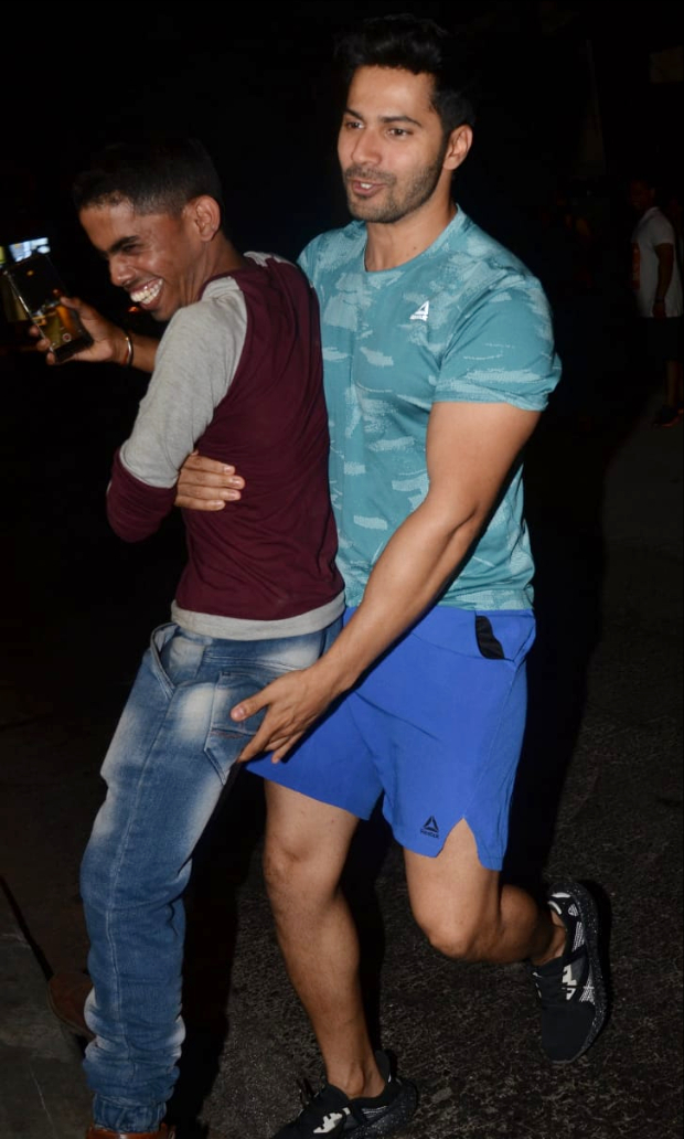 Varun Dhawan surprises a paparazzi as he lifts him his arms in this viral video Varun Dhawan surprises a paparazzi as he lifts him his arms in this viral video