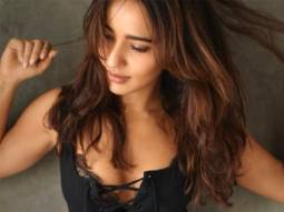 Neha Sharma sets the temperature soaring as she sizzles in a black monokoni