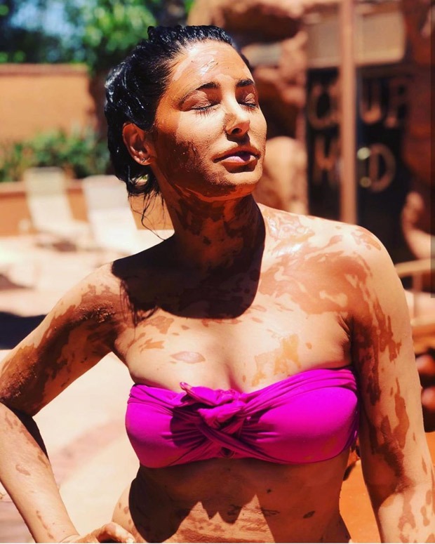 Nargis Fakhri soaks in the sun in pink bikini while enjoying mud bath Nargis Fakhri soaks in the sun in pink bikini while enjoying mud bath