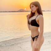 Sakshi Mallik flaunts her enviable curves in a black bikini as she poses in the backdrop of a sunset