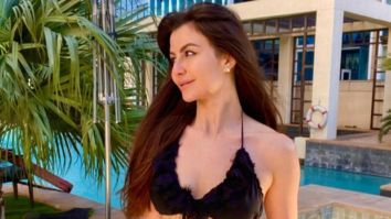 Giorgia Andriani sizzles in a black bikini by the pool