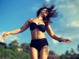 Kim Sharma stuns in a strapless black bikini as she poses at the beach