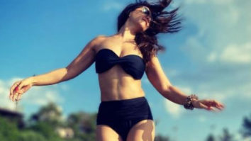Kim Sharma stuns in a strapless black bikini as she poses at the beach
