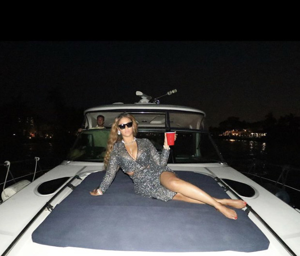 Beyoncé stuns in silver sheer wrap top and matching slit skirt she heads to Miami