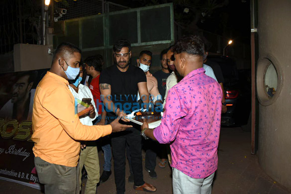 photos ajay devgn snapped cutting a birthday cake with fans 2