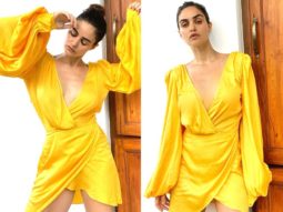 Gabriella Demetriades is a ray of sunshine in plunging neckline yellow mini wrap dress