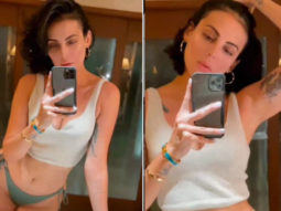 Mandana Karimi shares a video flaunting her curves in a bikini bottom and white crop-top