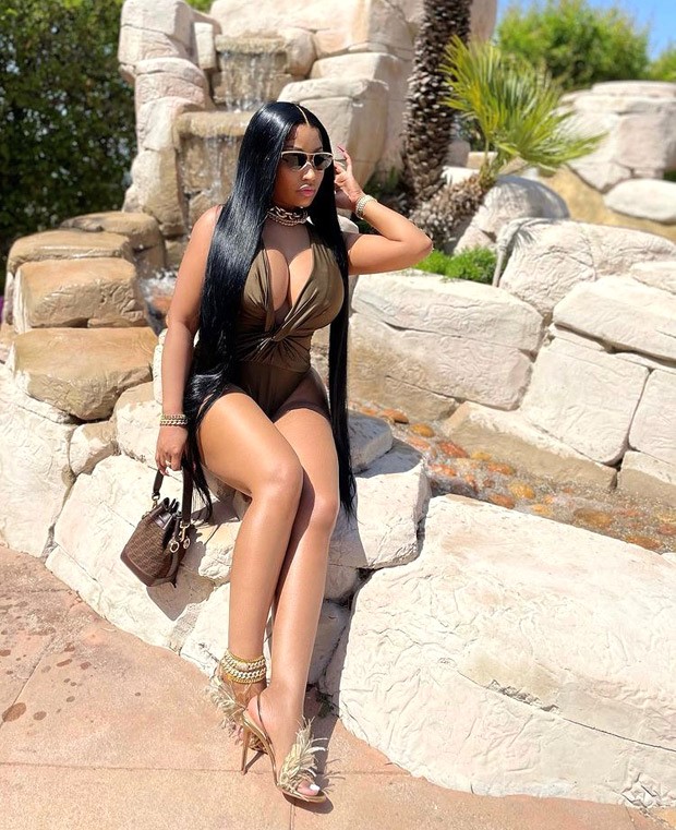 Nicki Minaj pairs her sexy plunging neckline seaweed green bodysuit with Fendi handbag