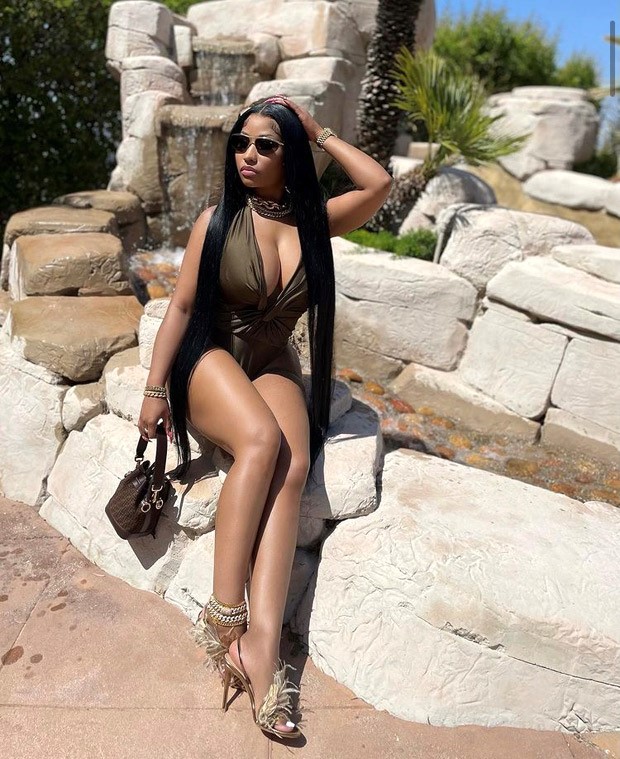 Nicki Minaj pairs her sexy plunging neckline seaweed green bodysuit with Fendi handbag