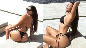 Kim Kardashian sizzles in steamy pictures posing by the pool in black bikini