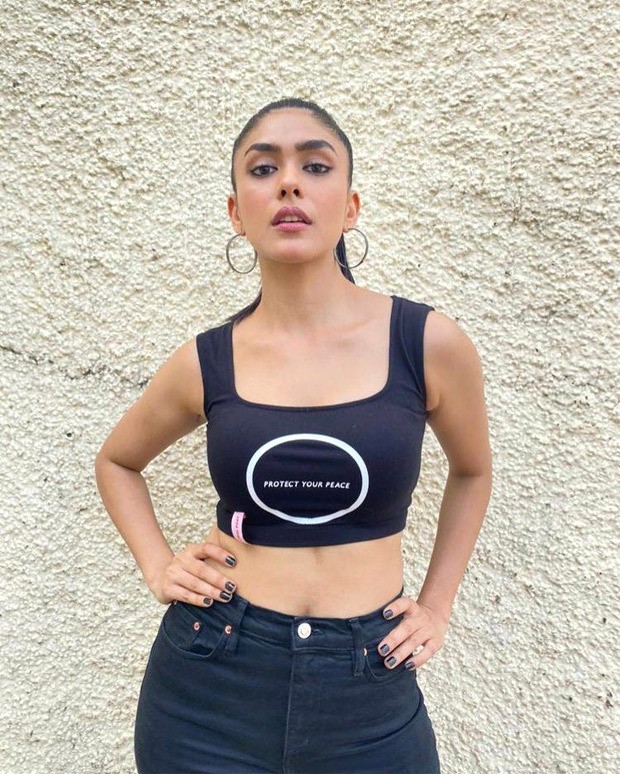 For Toofan promotions, Mrunal Thakur pairs crop top and flared denims with Christian Louboutin sneakers worth Rs. 62,795