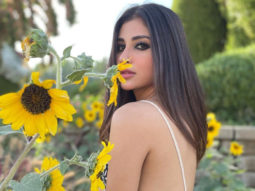 “Of sonnets & sunsets”, says Mouni Roy as she sways to a soulful track in black crop top, skirt, and a coat