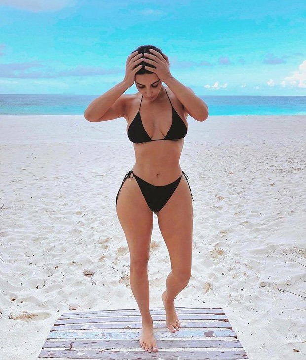 Kim Kardashian flaunts her resting beach face in black monokini bikini set