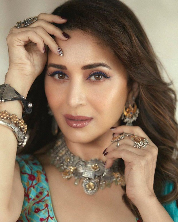 Madhuri Dixit looks gorgeous in a Turquoise pre-draped saree from Punit Balana worth Rs.35,500