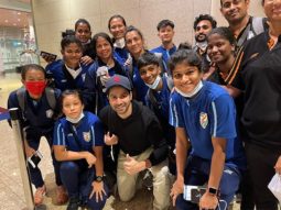 Varun Dhawan poses with the Indian Women’s Football team at the airport