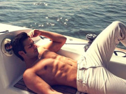 Varun Dhawan poses shirtless on a boat in the middle of the sea; Katrina Kaif reacts
