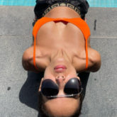 Malaika Arora calls Arjun Kapoor 'caption chor' as she posts pool side picture in orange bikini top and shorts