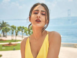 Sara Ali Khan is shining bright in yellow middie wrap around dress worth Rs.42,937 on the cover on Travel+leisure magazine