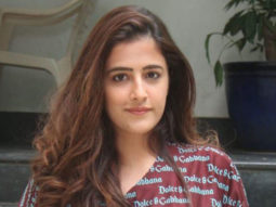 Nupur Sanon waves as she poses for paps