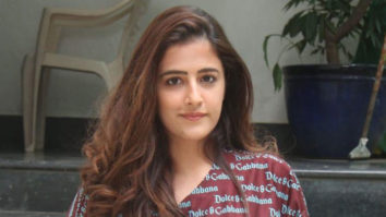 Nupur Sanon waves as she poses for paps