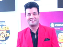 Varun Sharma poses for paps in a bright red suit