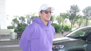 Vijay Varma smiles for paps in a purple hoodie and a cap at the airport