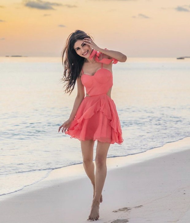 Mouni Roy ‘dances with the waves’ in a bright pink dress in new photos from Maldives vacation