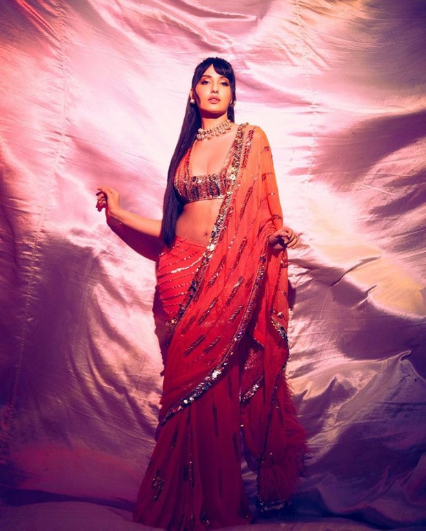 Nora Fatehi in Manish Malhotra’s orange sequined saree is setting screens ablaze
