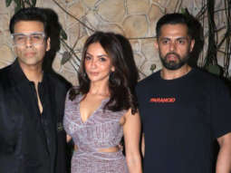 Karan Johar and Seema Sajdeh smile as they get clicked