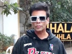 Karan Johar poses for paps in a hoodie and funky glasses