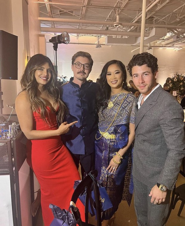 Priyanka Chopra sets the temperature soaring in a risque red gown at a wedding she attended with husband Nick Jonas 