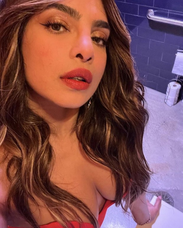Priyanka Chopra sets the temperature soaring in a risque red gown at a wedding she attended with husband Nick Jonas 