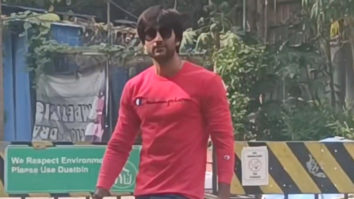 Meezaan Jafri poses with fans in red sweatshirt