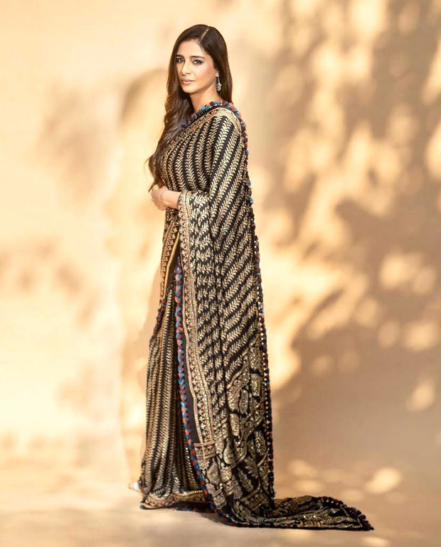 Tabu’s black and golden saree by Abu Jani-Sandeep Khosla for Drishyam 2 promotions can work everywhere from sangeet celebrations to cocktail parties