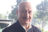 Anupam Kher greets his fans & paps on the airport