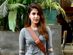 Rhea Chakraborty smiles as she poses for paps