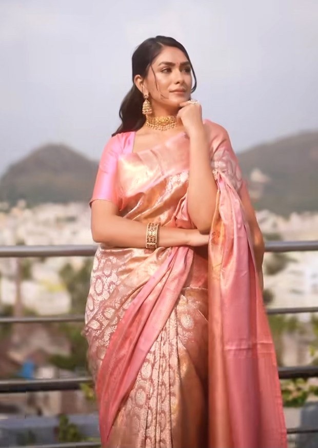 Mrunal Thakur, dressed in a blush pink brocade saree and with gajra in her hair, has our whole attention
