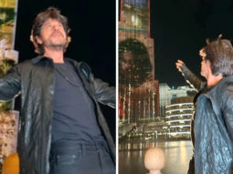 Shah Rukh Khan does his signature pose as the Pathaan trailer is screened on Burj Khalifa
