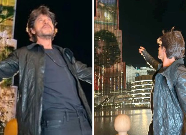 Shah Rukh Khan does his signature pose as the Pathaan trailer is screened on Burj Khalifa