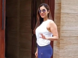 Sophie Choudry smiles for paps as she plays with a cute dog